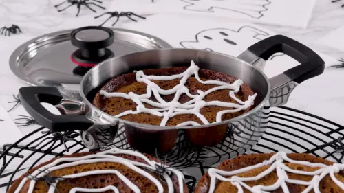 pan with brownie decorated with cobweb