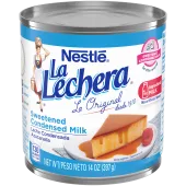 A white can of sweetened condensed milk with blue labels beside the La Lechera logo and a plate of flan.